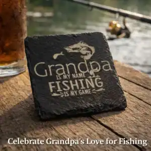 Grandpa Is My Name Fishing Is My Game slate coaster on rustic table near lake
