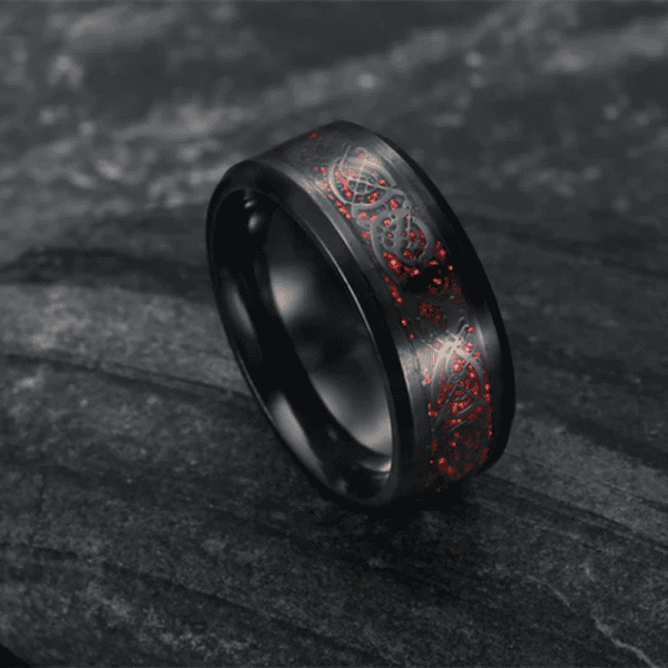 Black ring with red illuminated intricate laser engraving design.