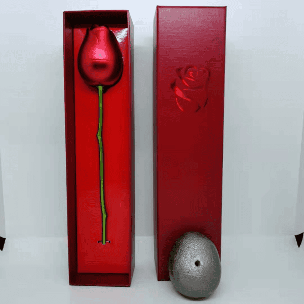 Elegant laser-etched rose design on a red gift box with a preserved flower inside.