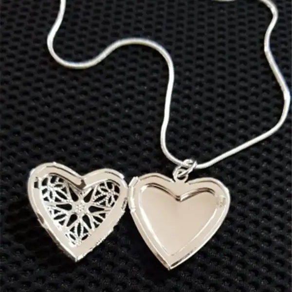 Silver heart necklace with detailed laser-cut pattern, perfect for custom jewelry.