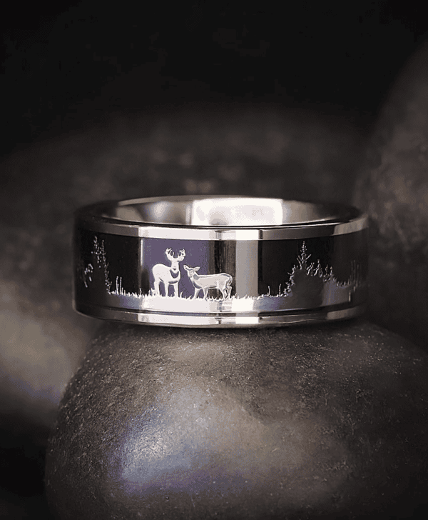 Custom engraved tungsten wedding band with deer stag silhouette and wood inlay.